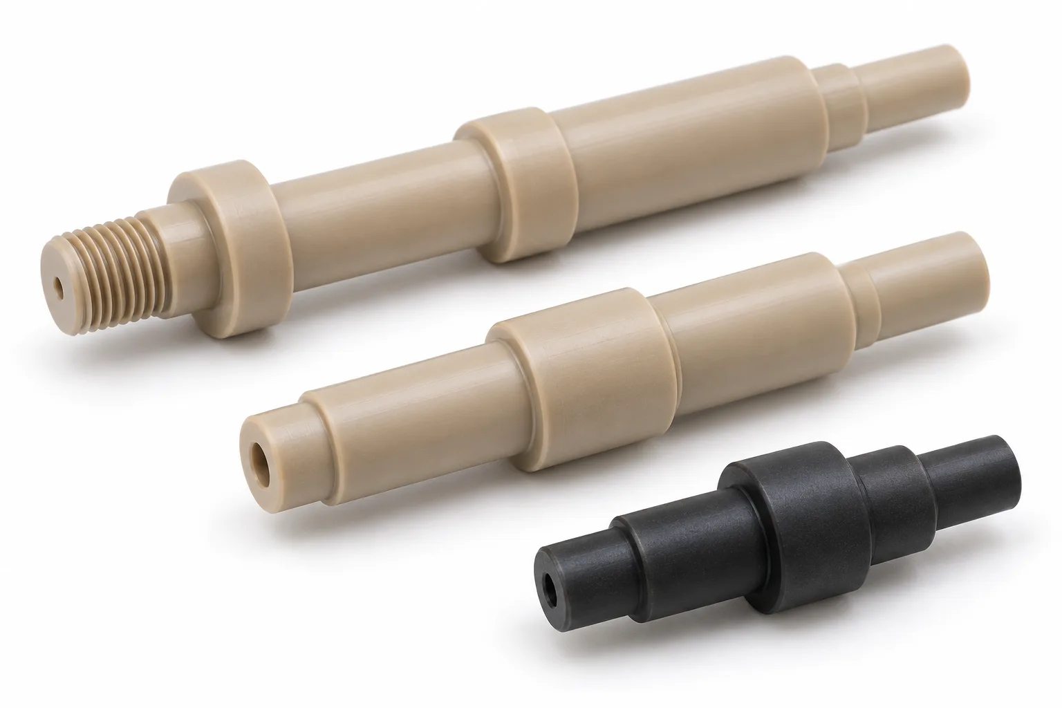 Natural beige and black PEEK shafts with custom stepped and threaded features