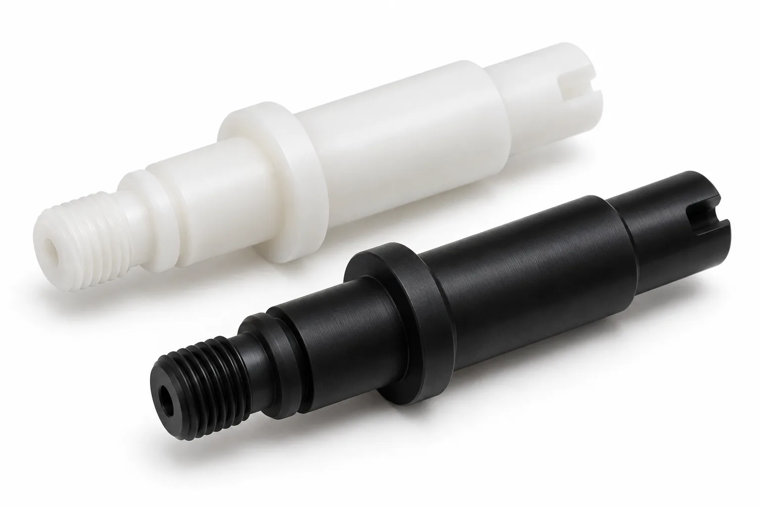 Fine machined white and black acetal shaft ends with controlled chamfers and thread relief